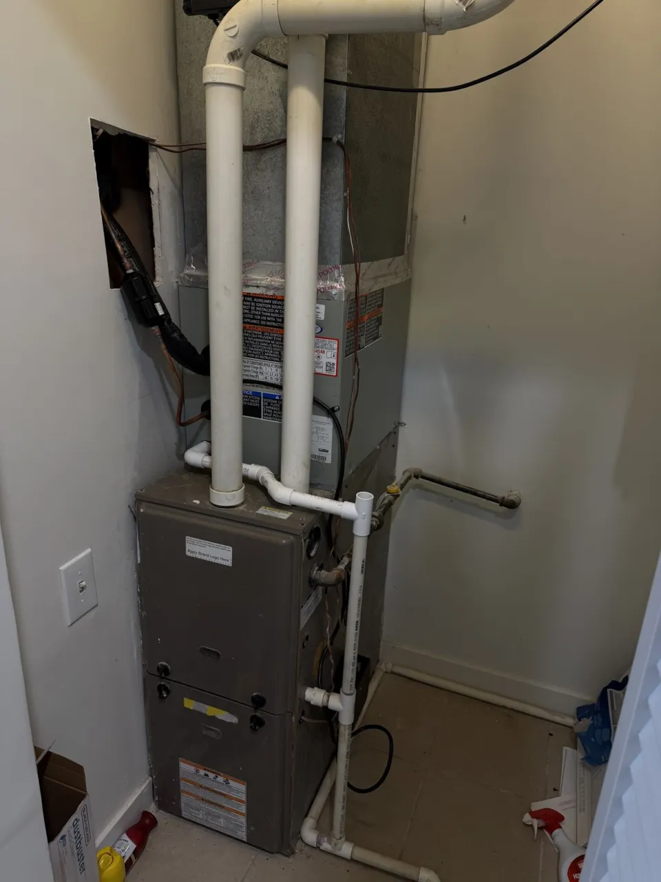 A new furnace and evaporator coil installed in the same closet, sheet metal transition sealed.