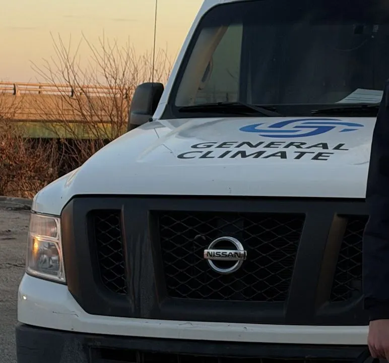 The General Climate van parked at sunset, the company mark on the hood.