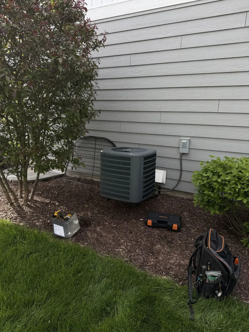 The previous outdoor air conditioner beside the siding in Naperville.