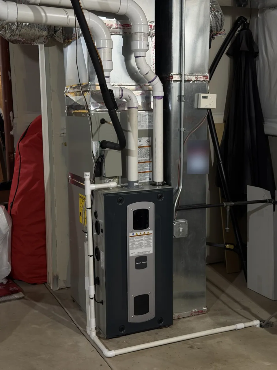 The replacement American Standard furnace and indoor coil in the same basement.