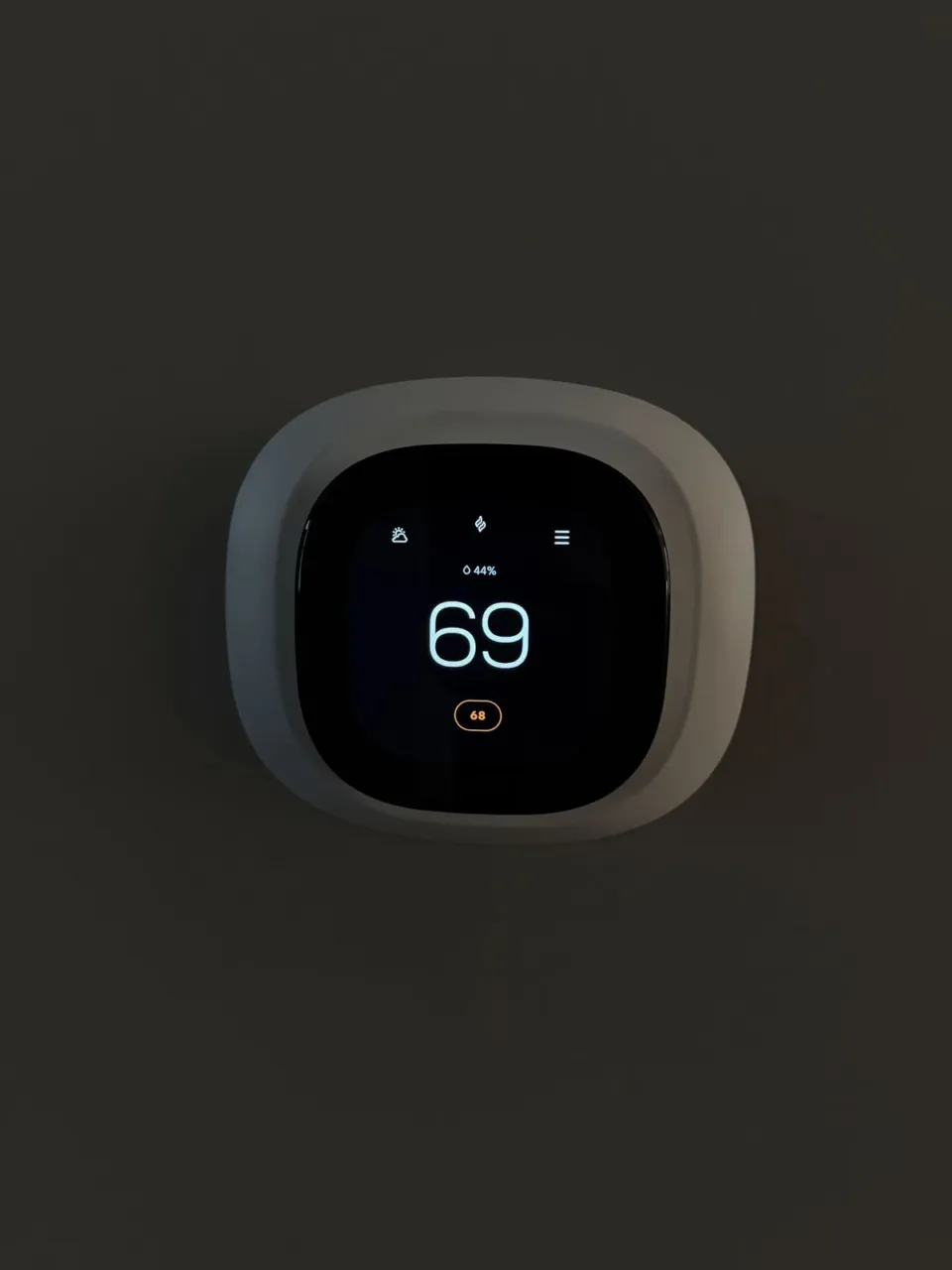 The wall thermostat photographed with the completed Naperville installation.